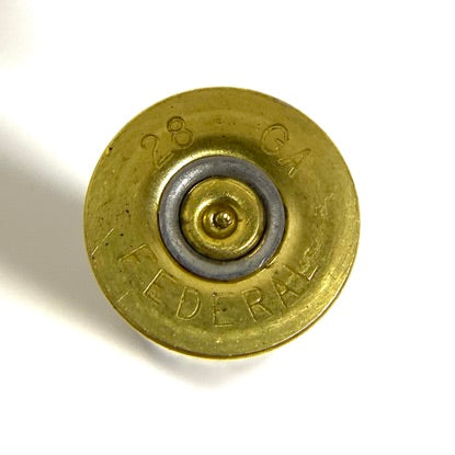 Extreme close-up of a single 28 gauge brass hull base with legible 28 GA and Federal headstamp markings