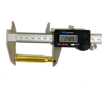 A digital caliper measuring the length of a single 30-06 brass shell, showing a digital readout of 2.489.

