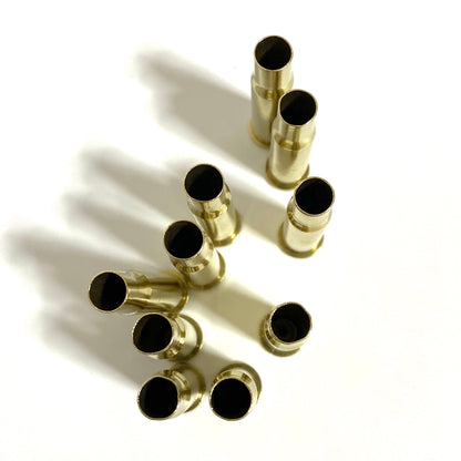 Top view of polished 30-30 brass casing necks, standing upright, showing tumbled gold finish and open mouths.
