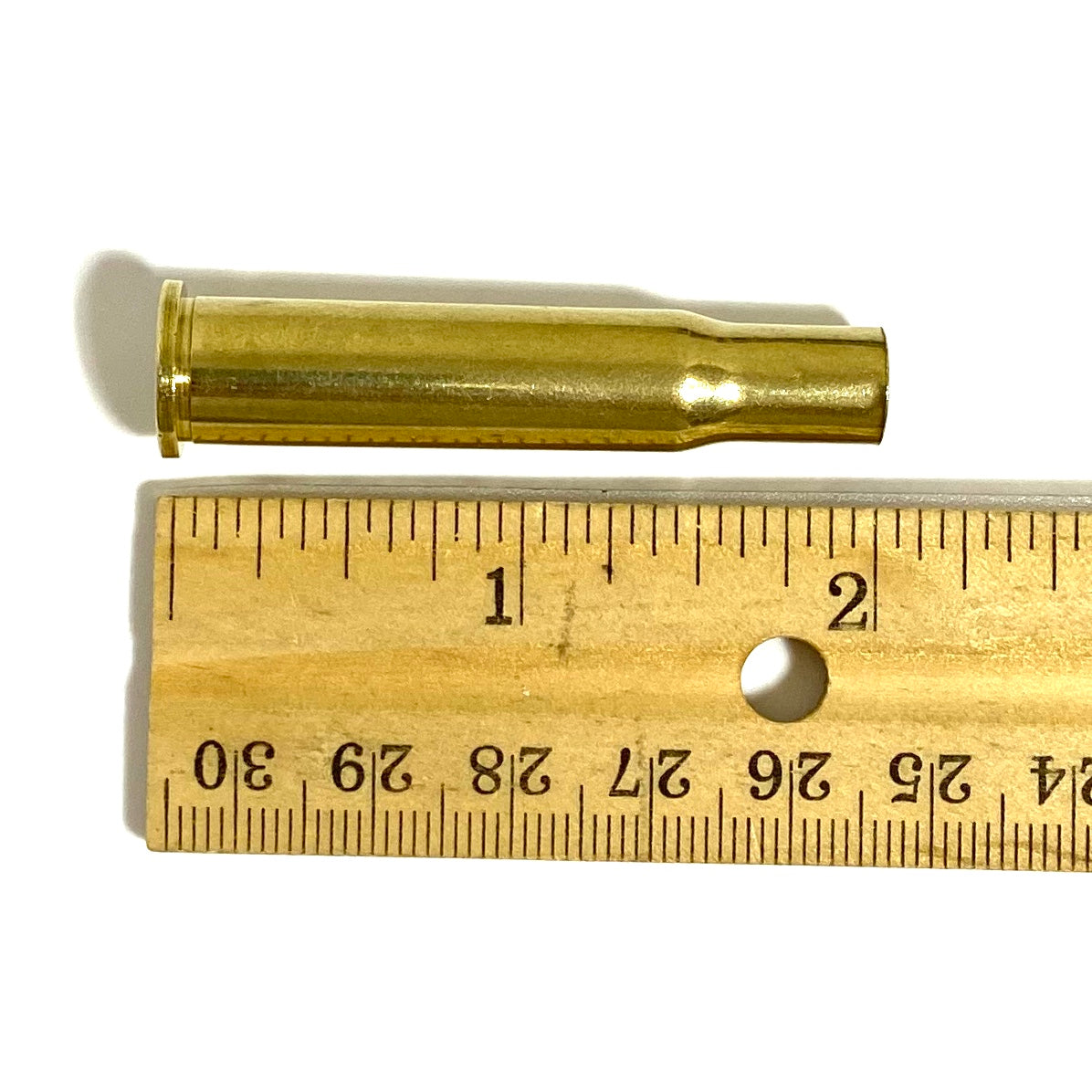 Size dimensions of a 2-inch polished 30-30 Winchester brass casing next to a ruler for crafting and DIY jewelry.
