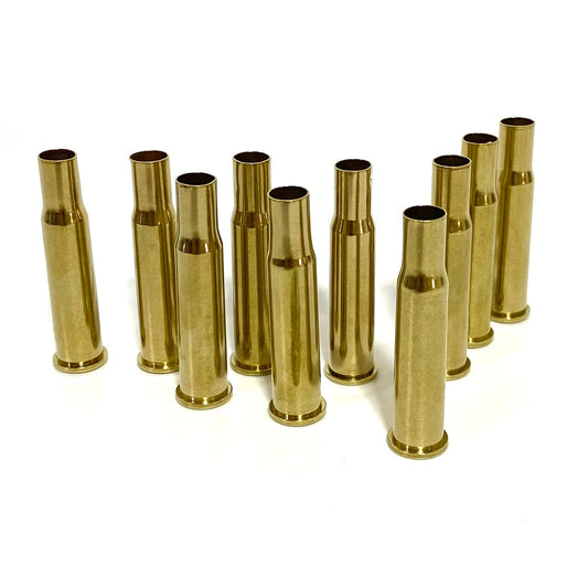 10 polished 30-30 Winchester brass casings standing upright, empty once-fired shells with a bright yellow-gold shine.
