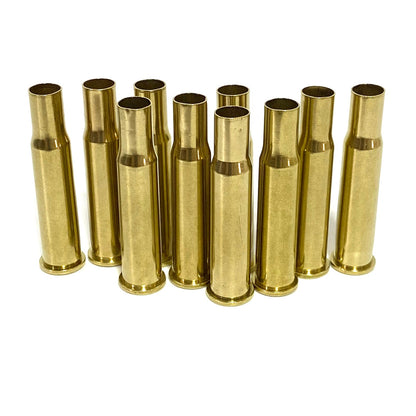 Twelve upright 30-30 Winchester brass casings in a grid, showing bright tumbled gold finish and empty mouths.
