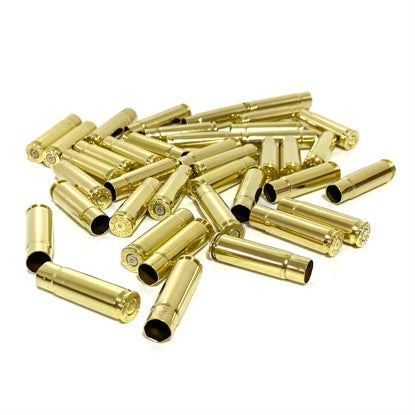 A pile of empty cleaned 300 Blackout brass rifle casings lying on a solid white background.