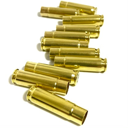 Stacked gold tone 300 Blackout spent brass casings on a clean white background.
