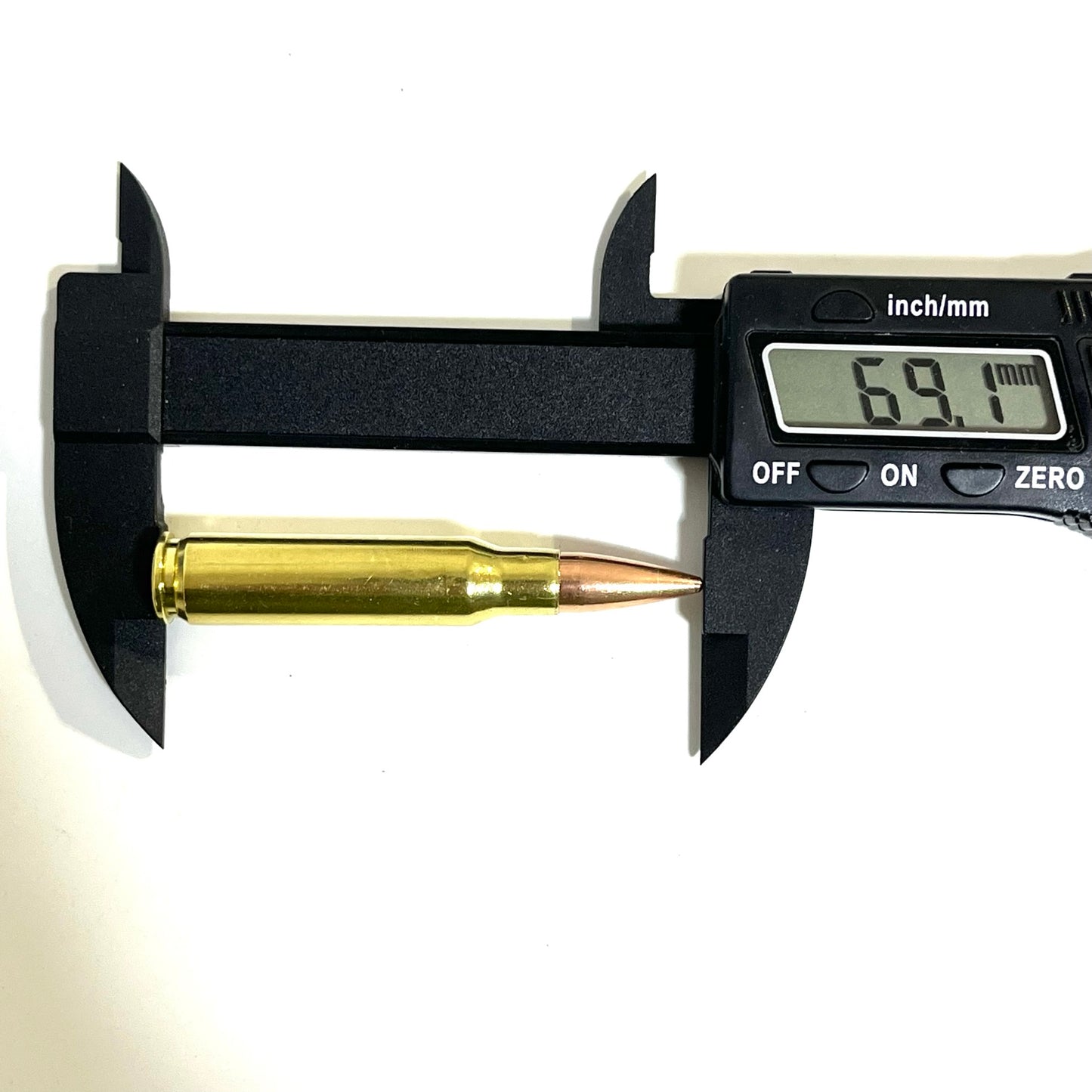 Single brass .308 prop fake round measured lengthwise with digital calipers reading 69.1mm