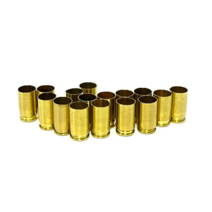 15 empty .380 Auto spent brass casings standing upright on a white background