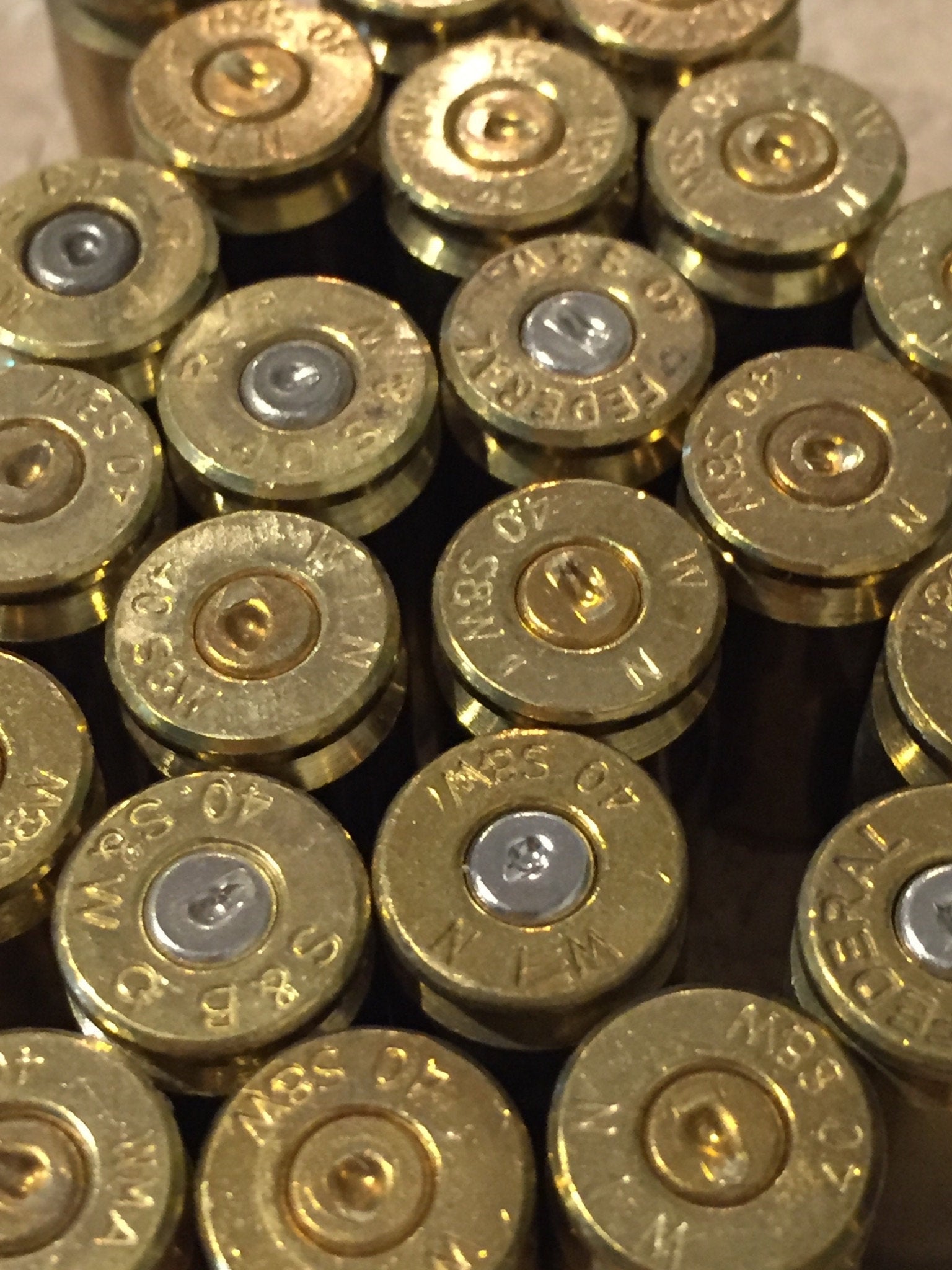 Brass casings top view of headstamps and spent silver and gold primers