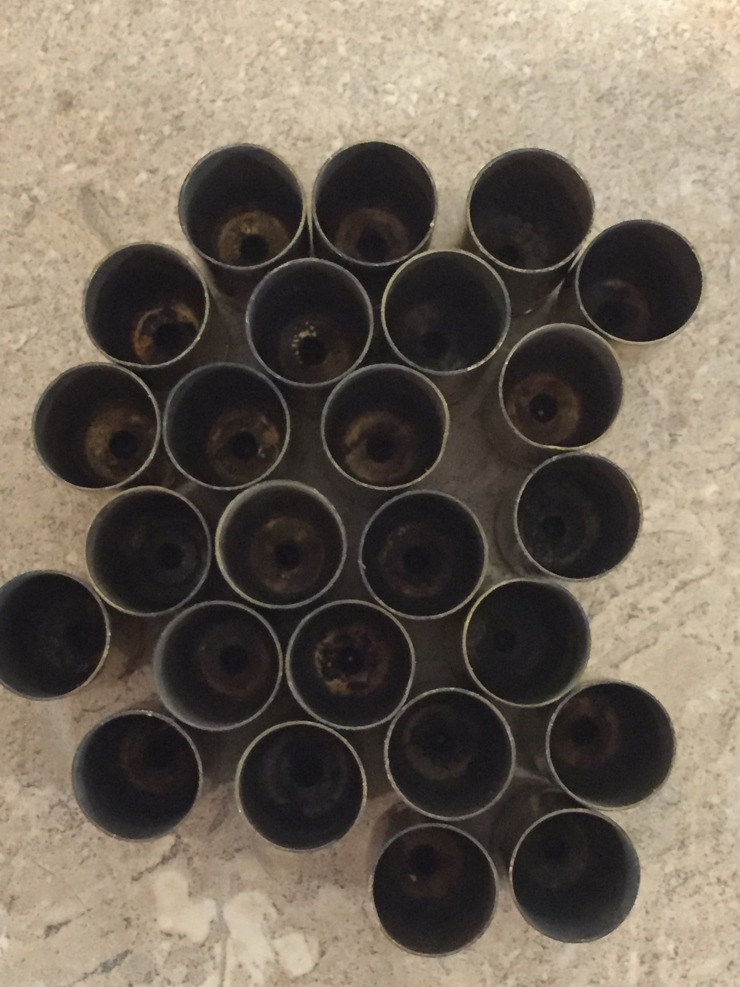 Overhead view of gold .40 S&W brass casings viewed from the open mouth end, showing hollow interiors