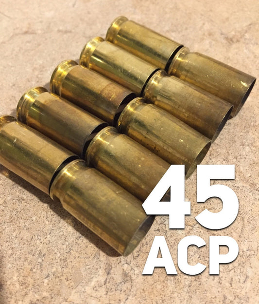 10 brass .45 ACP casings fanned in a diagonal stack on a stone surface, with a bold white "45 ACP" text graphic overlay