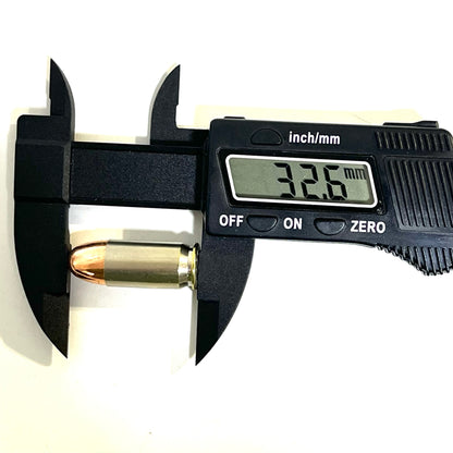 A single nickel 45 ACP dummy round measured lengthwise with a black digital caliper showing 32.6 mm.