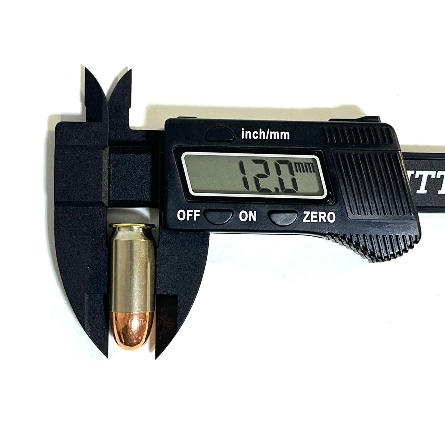 A single nickel 45 ACP dummy round measured with a black digital caliper displaying a reading of 12.0 mm.