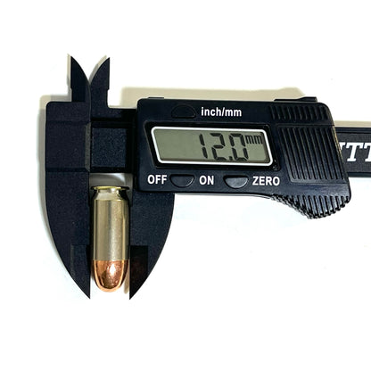 A single nickel 45 ACP dummy round measured with a black digital caliper displaying a reading of 12.0 mm.