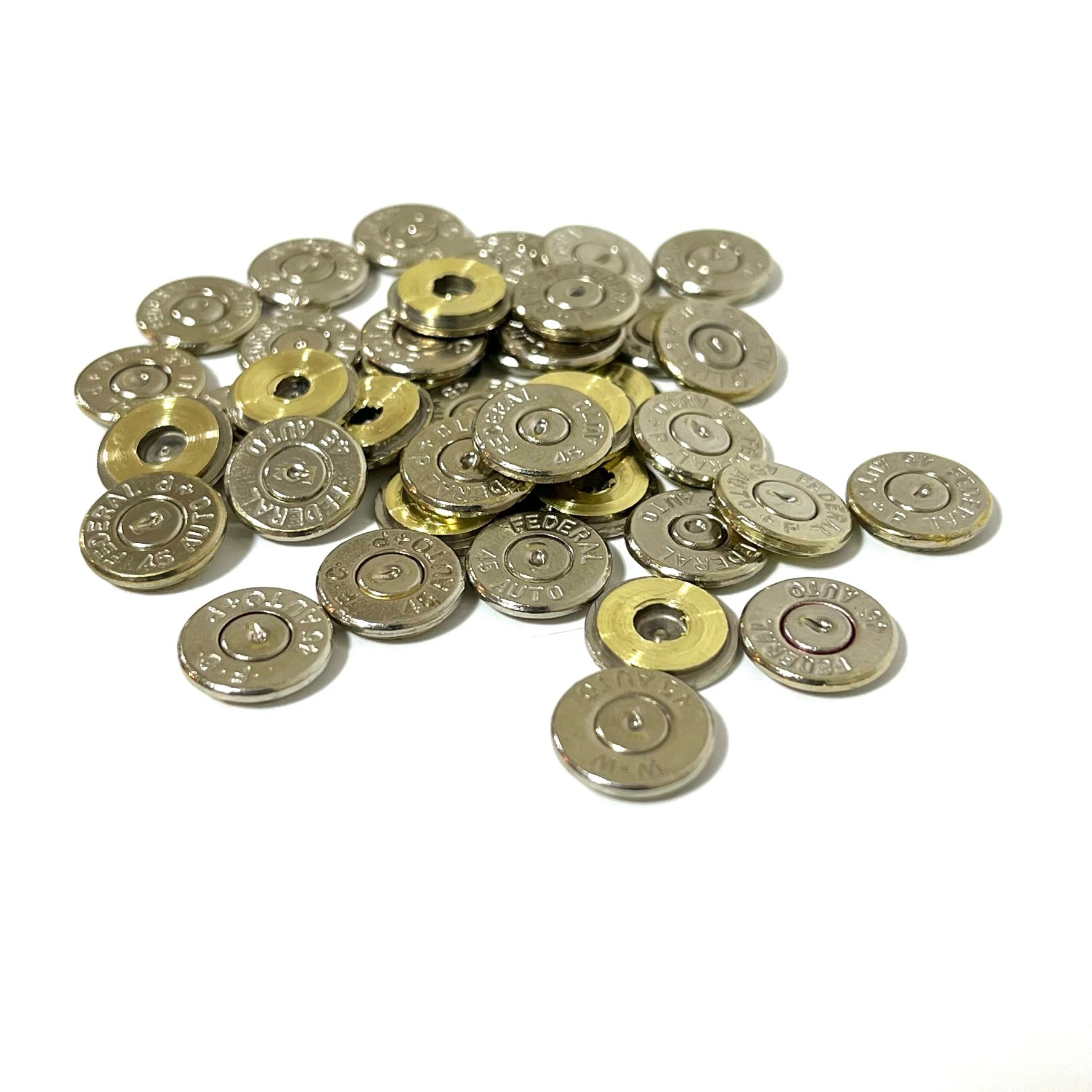 A pile of forty-five auto nickel bullet slices grouped together on a solid white background for earnings. .
