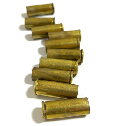 Row of gold .45 Colt brass casings arranged diagonally on a white background