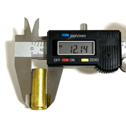 Digital caliper measuring the diameter of a gold .45 Colt brass casing, reading 12.14mm