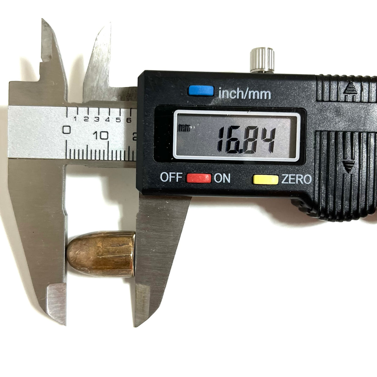 Digital caliper measuring the length of a fired 45 ACP bullet showing 16.84 mm
