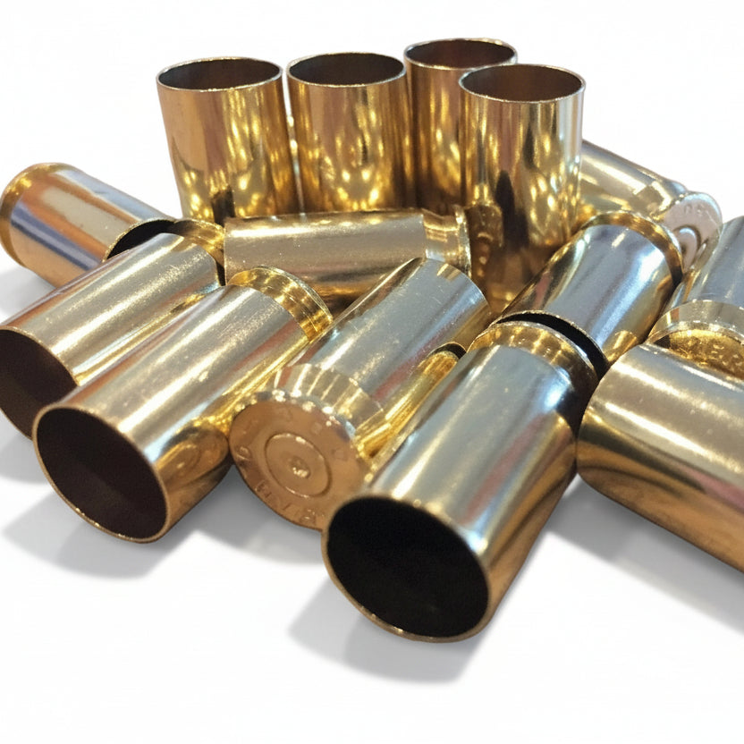 A small jumbled pile of gold 45 ACP brass, mouths facing different directions, one headstamp partly visible.