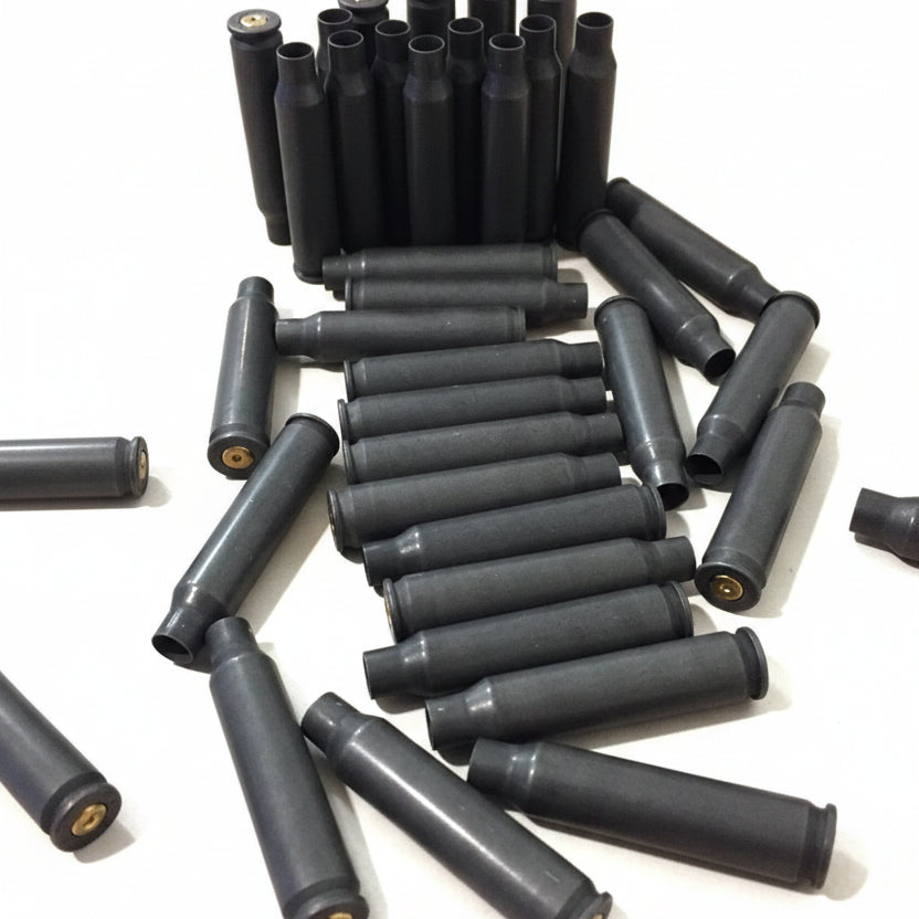 Empty gray steel cartridges stand upright and lie flat in a swirled arrangement, showing brass primers.