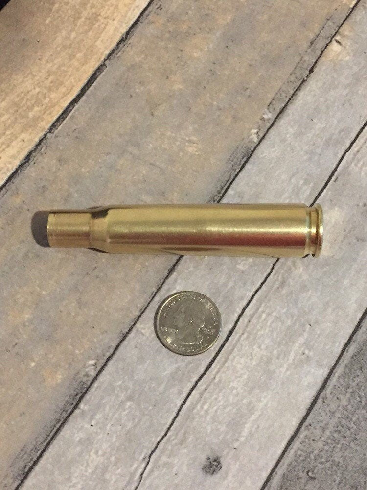 A single .50 BMG brass casing sourced from genuine military-surplus once-fired brass.