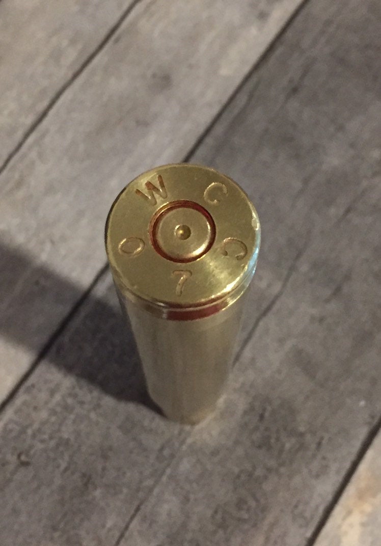.50 BMG brass casing, approximately 3.91 inches in case length, hand-polished.
