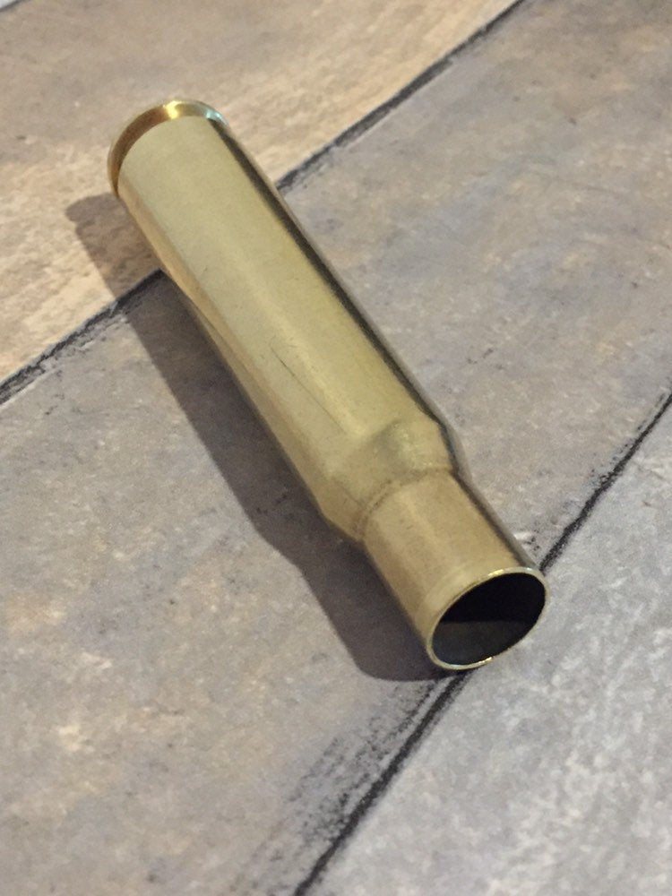 Polished .50 BMG casing with mixed headstamps, since these are genuine recovered brass.