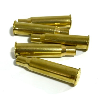 Six polished 7.62x54R empty brass rifle casings scattered on a white background.
