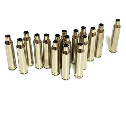 A group of empty nickel-plated 7mm Remington Magnum rifle casings standing vertically against a white background.
