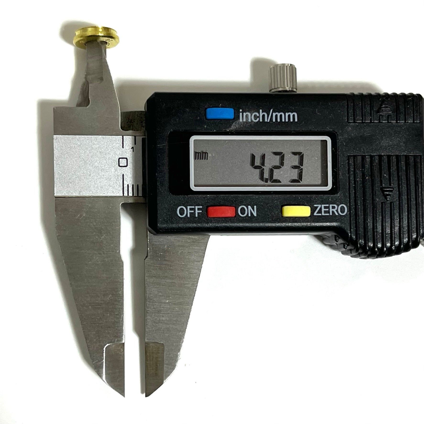 A caliper's inner jaws measure the hole diameter of a 9mm brass bullet slice cut at 4.23 mm.