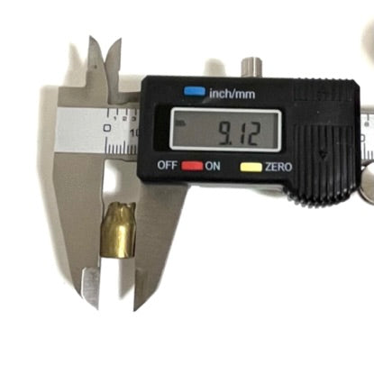 Digital caliper measuring the diameter of a spent 9mm fired bullet showing 9.12 mm
