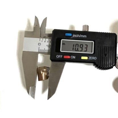 Digital caliper measuring the diameter of a spent 9mm fired bullet showing 10.93 mm