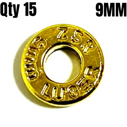 A single brass 9mm deprimed brass bullet slice showing engraved headstamp markings around the rim.