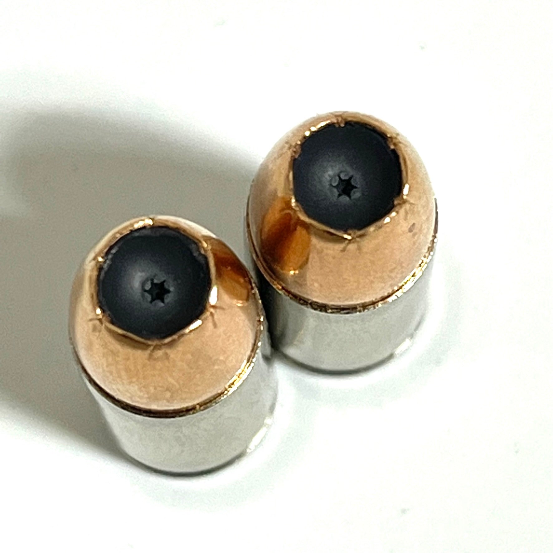 Group of inert 9MM Luger nickel dummy rounds with jacketed hollow point bullets. Once-fired recovered brass casings — completely safe, no powder or primer. Ideal for film props and jewelry.