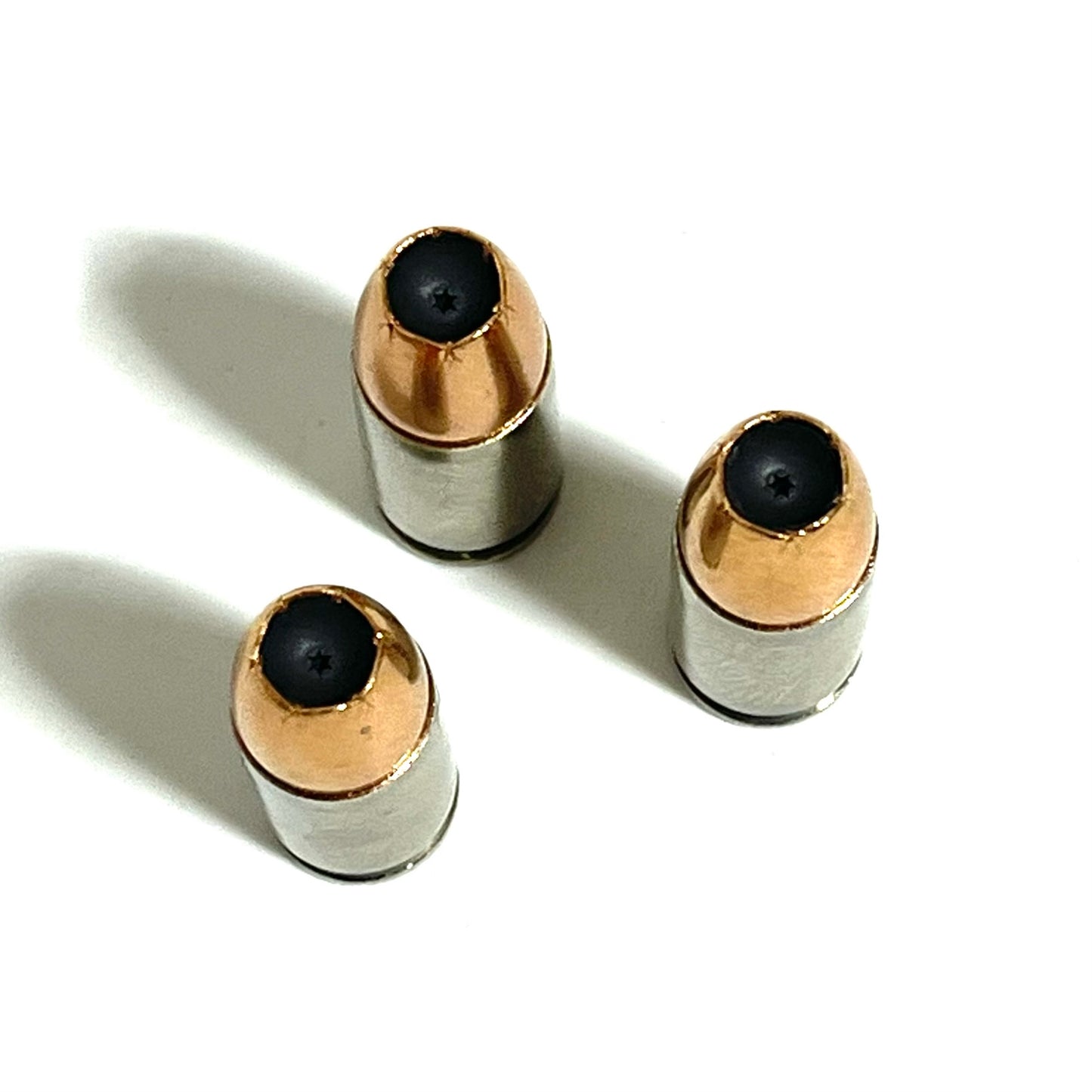 Digital caliper measuring the overall length of an inert 9MM Luger nickel dummy round at 28.39mm. Authentic once-fired brass casing with JHP bullet. Accurate scale reference for crafters and prop makers.