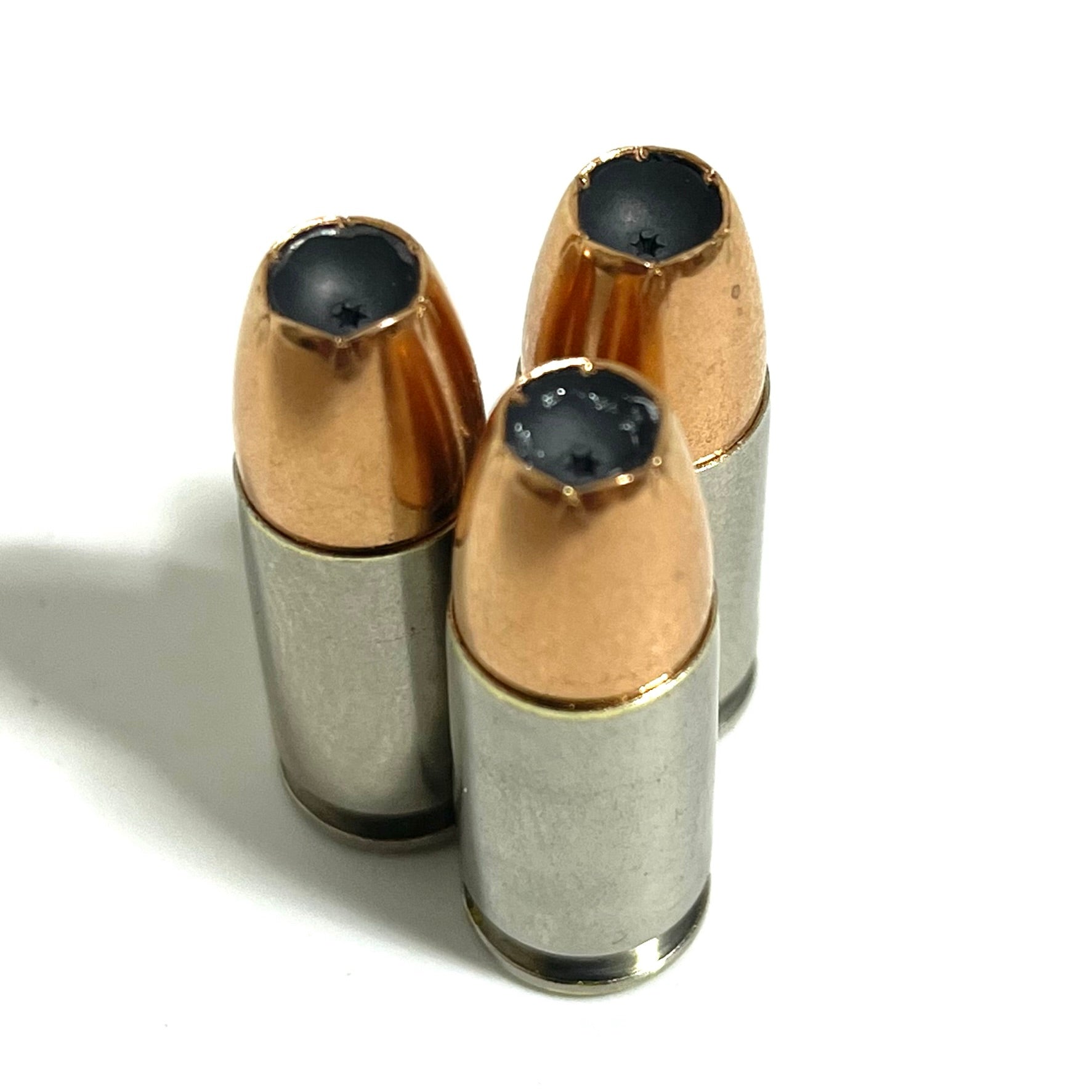 Side profile of inert 9MM Luger nickel-plated dummy round with new JHP bullet seated in once-fired brass casing. Safe for display, cosplay, and ammo crafts.

