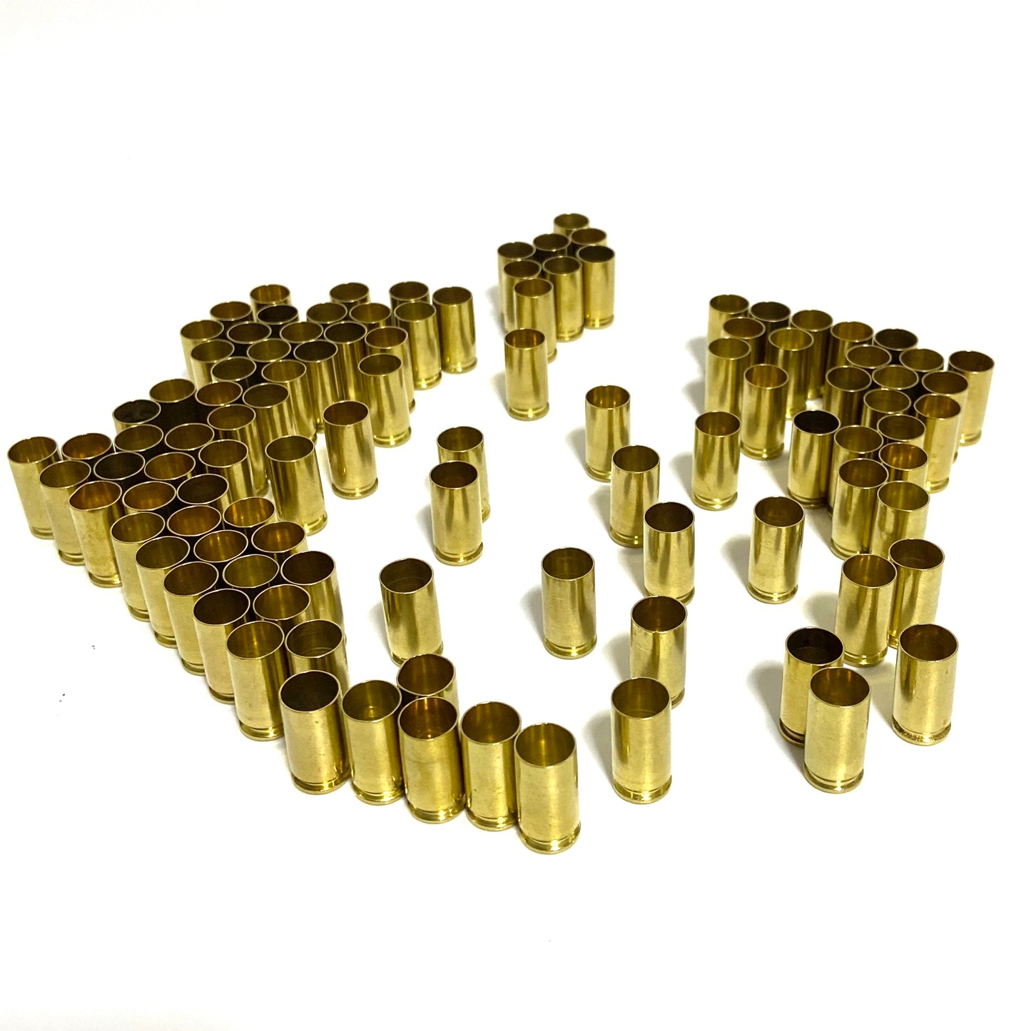 Orderly rows of polished 9mm brass shells showing open mouths.
