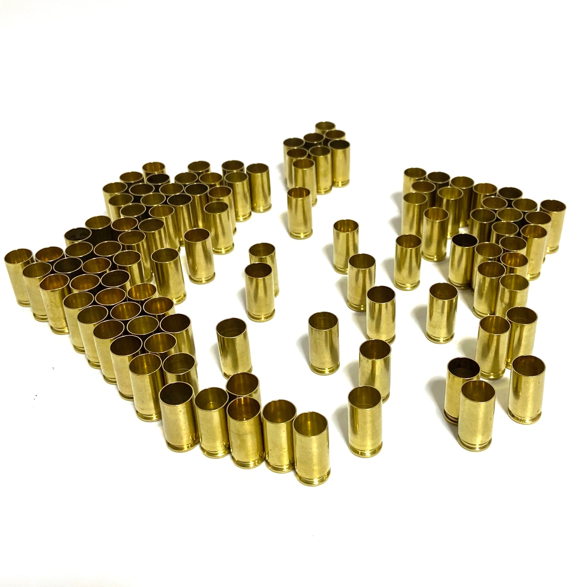 Orderly rows of polished 9mm brass shells showing open mouths.
