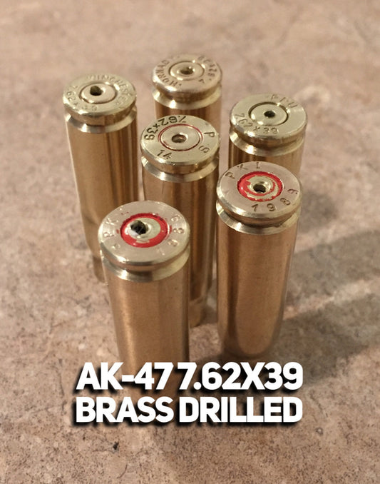 Five standing brass casings showing headstamps. Image text reads: AK-47 7.62X39 BRASS DRILLED.
