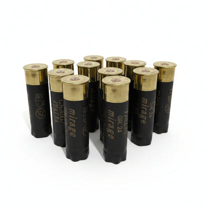 Group of black Mirage shotgun casings standing upright, showing brass headstamp caps on a wood surface.