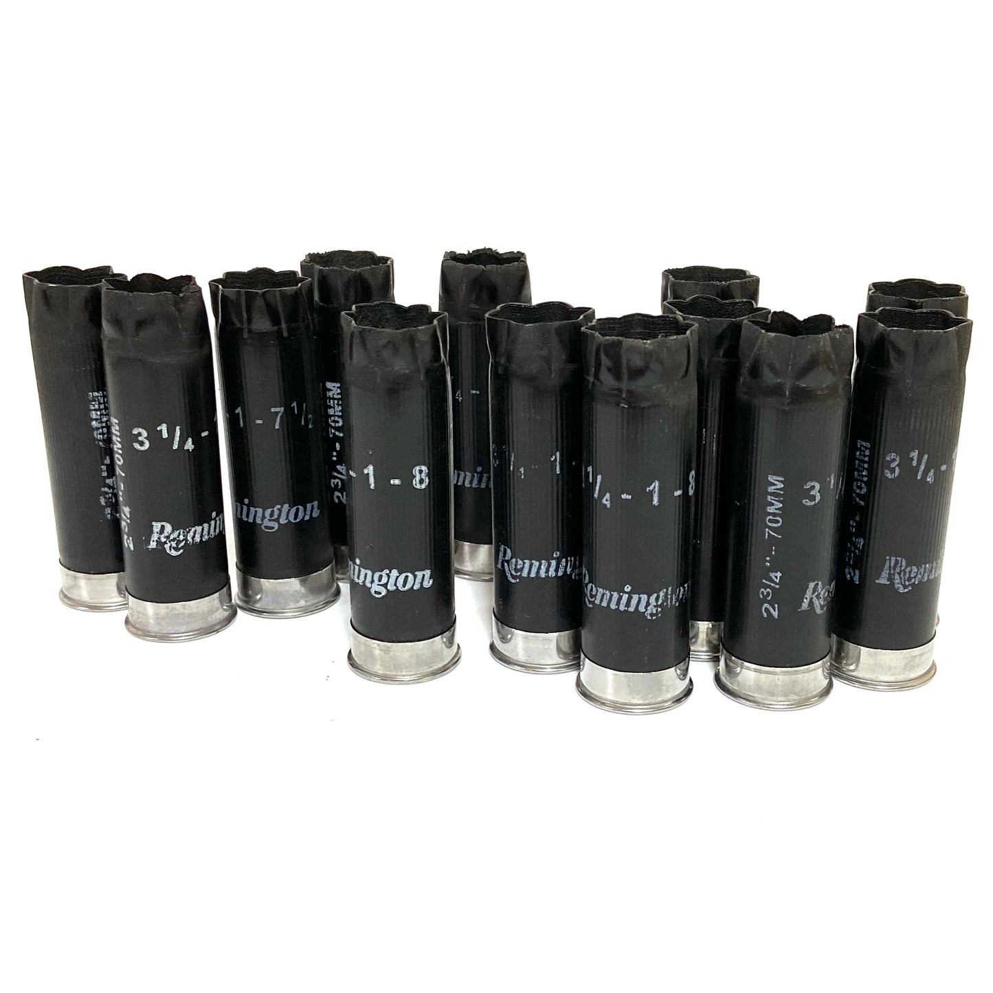 Group of black Remington 12 gauge spent shotgun shells standing upright on a white background.

