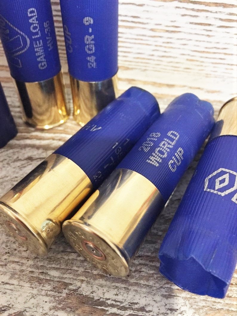 Closeup of blue Rio 12 gauge shotgun shells with gold bases, printed with ‘2018 World Cup’ and ‘Game Load’ text