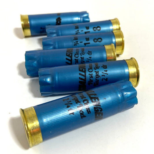 Six star-crimped blue Challenger 12 gauge shotgun shell hulls fanned out