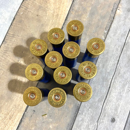 10 brass heads of blue Fiocchi 16 gauge shotgun shells viewed from above showing headstamp text
