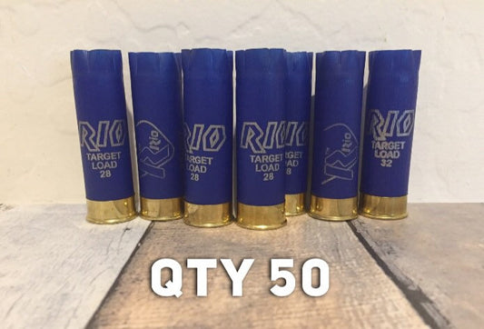 Seven blue Rio 12 gauge shotgun hulls standing upright in a row on a wood surface with white QTY 50 text overlay.