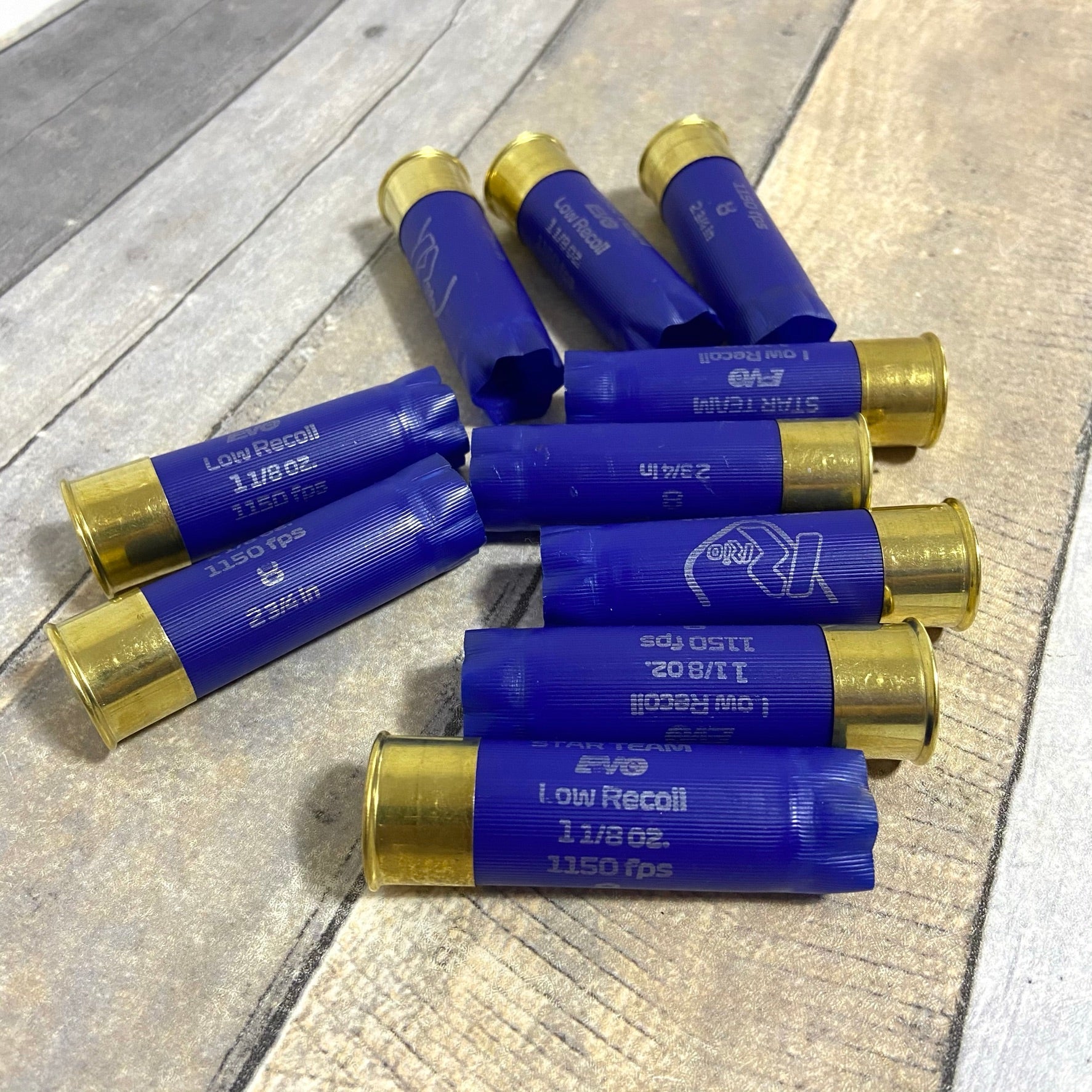 Blue Rio 12 Gauge Once Fired Hulls On Wood Surface