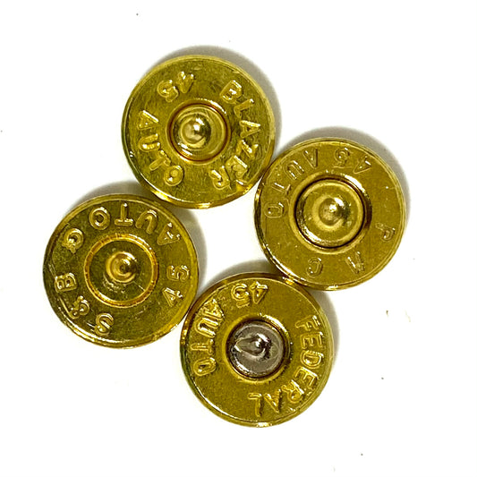 Four gold 45 ACP bullet slices clustered together, showing mixed headstamps including BLAZER and FEDERAL markings.