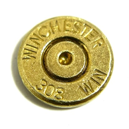Brass slice with Winchester 308 headstamp and gold primer, macro shot on white background