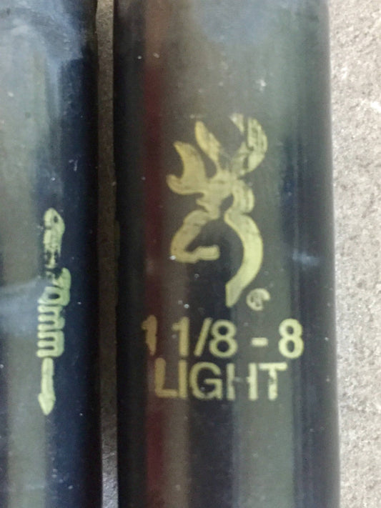 Close-up of two black Browning shotgun shells, one marked 70mm and the other stamped with a logo and load info.