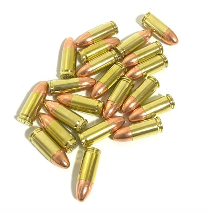 Large pile of 9mm dummy rounds with polished brass casings and round-nose bullets on white background.

