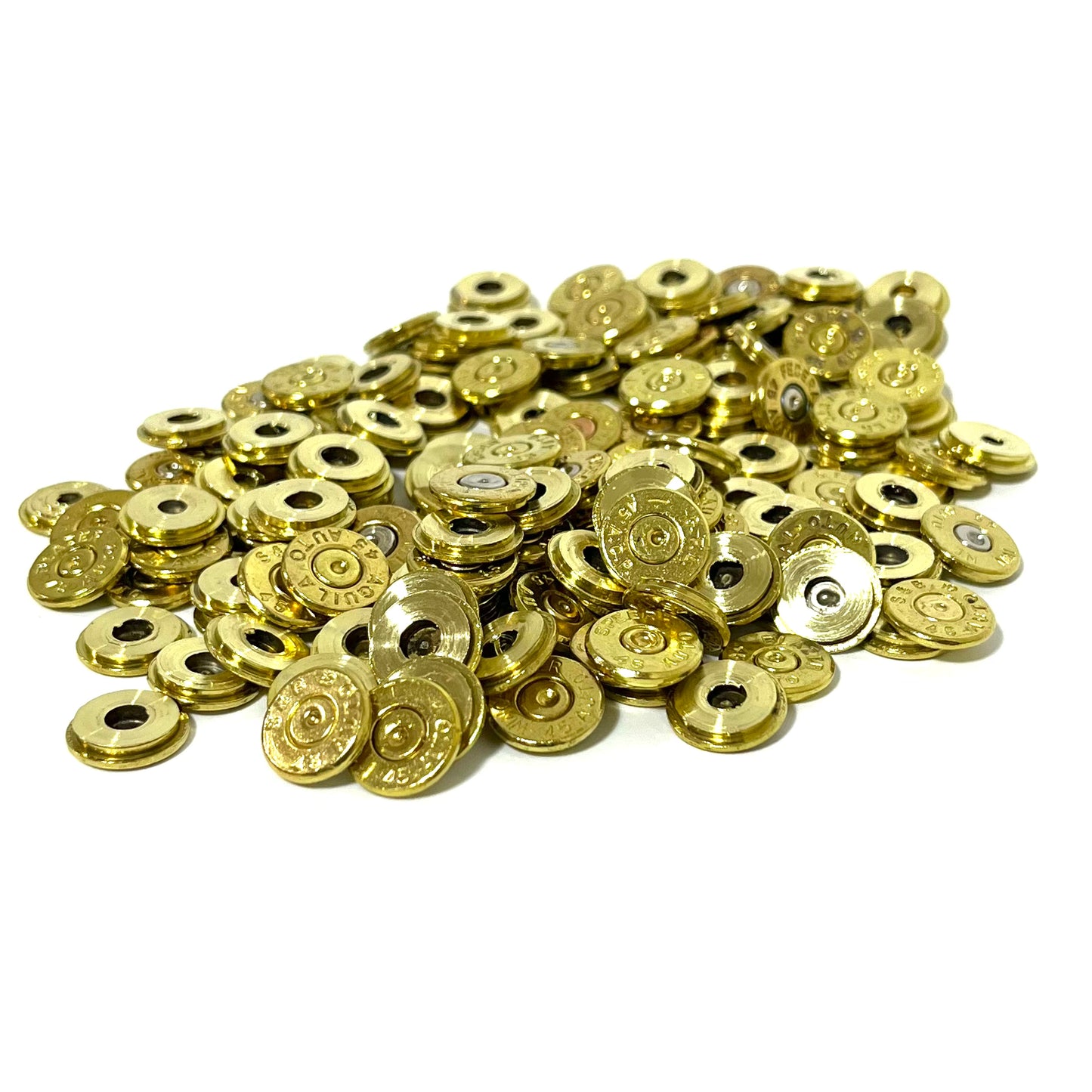 A large pile of gold brass slices heaped together, with headstamp markings and center holes visible throughout.