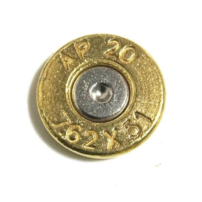 Single brass casing slice with headstamp reading AP 20 7.62x51, macro shot on white background